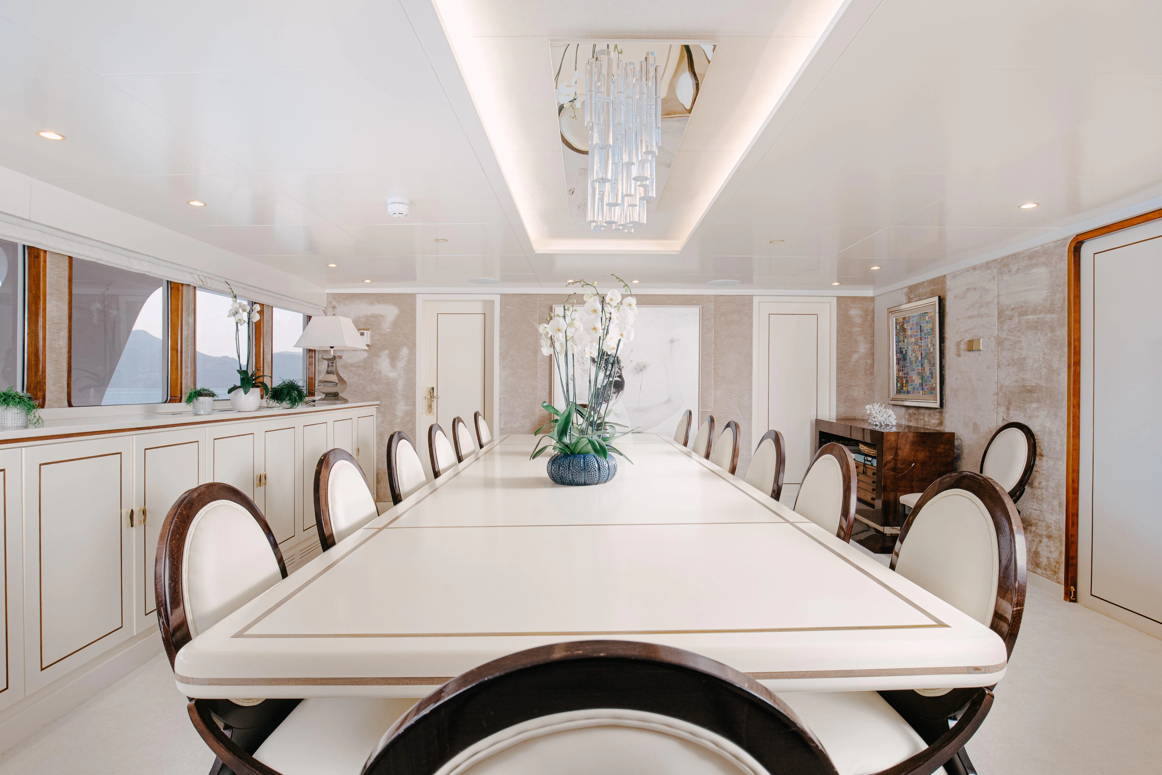 a large white table with chairs around it aboard ITOTO Yacht for Charter