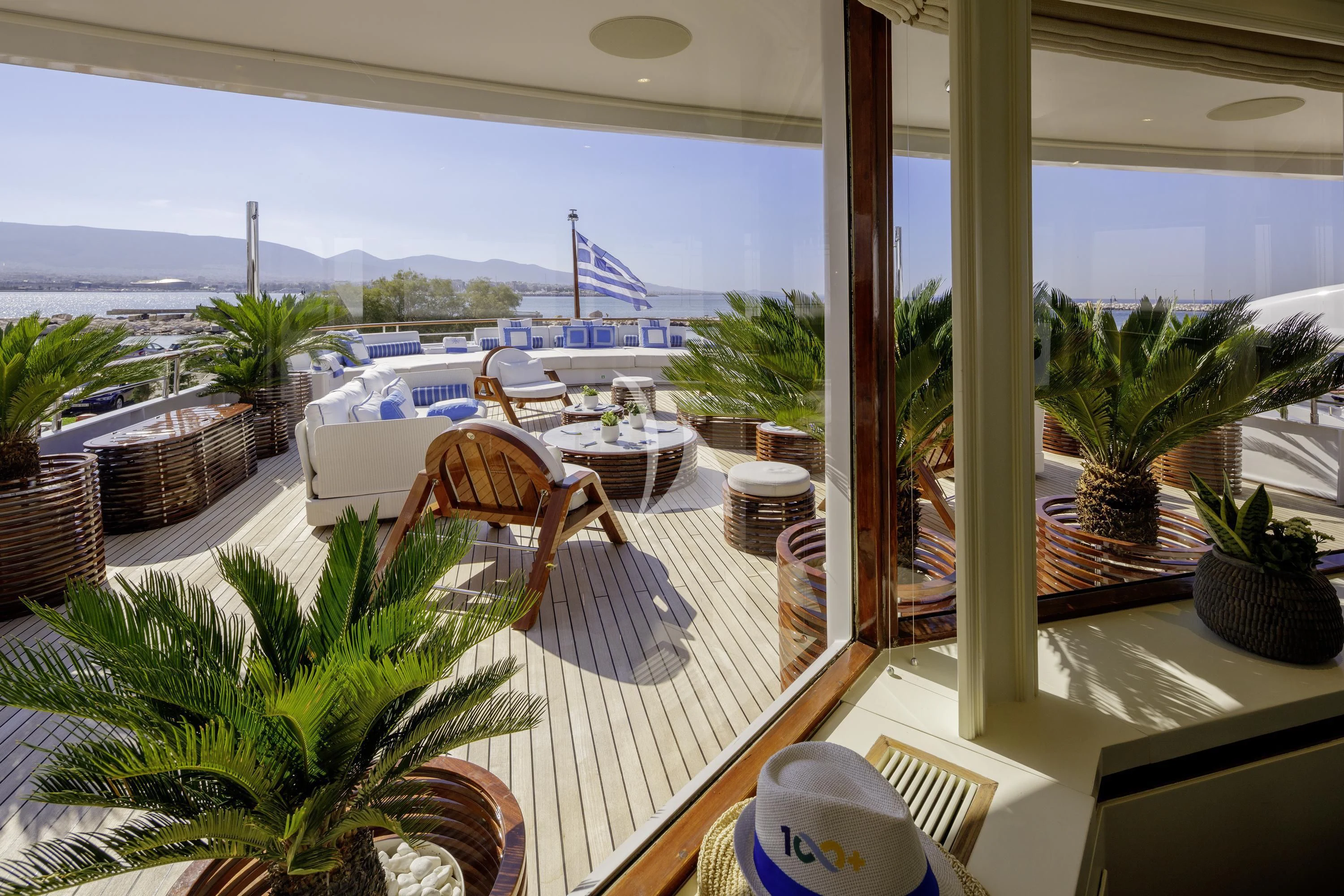 a balcony with a view of the ocean and boats aboard ITOTO Yacht for Charter