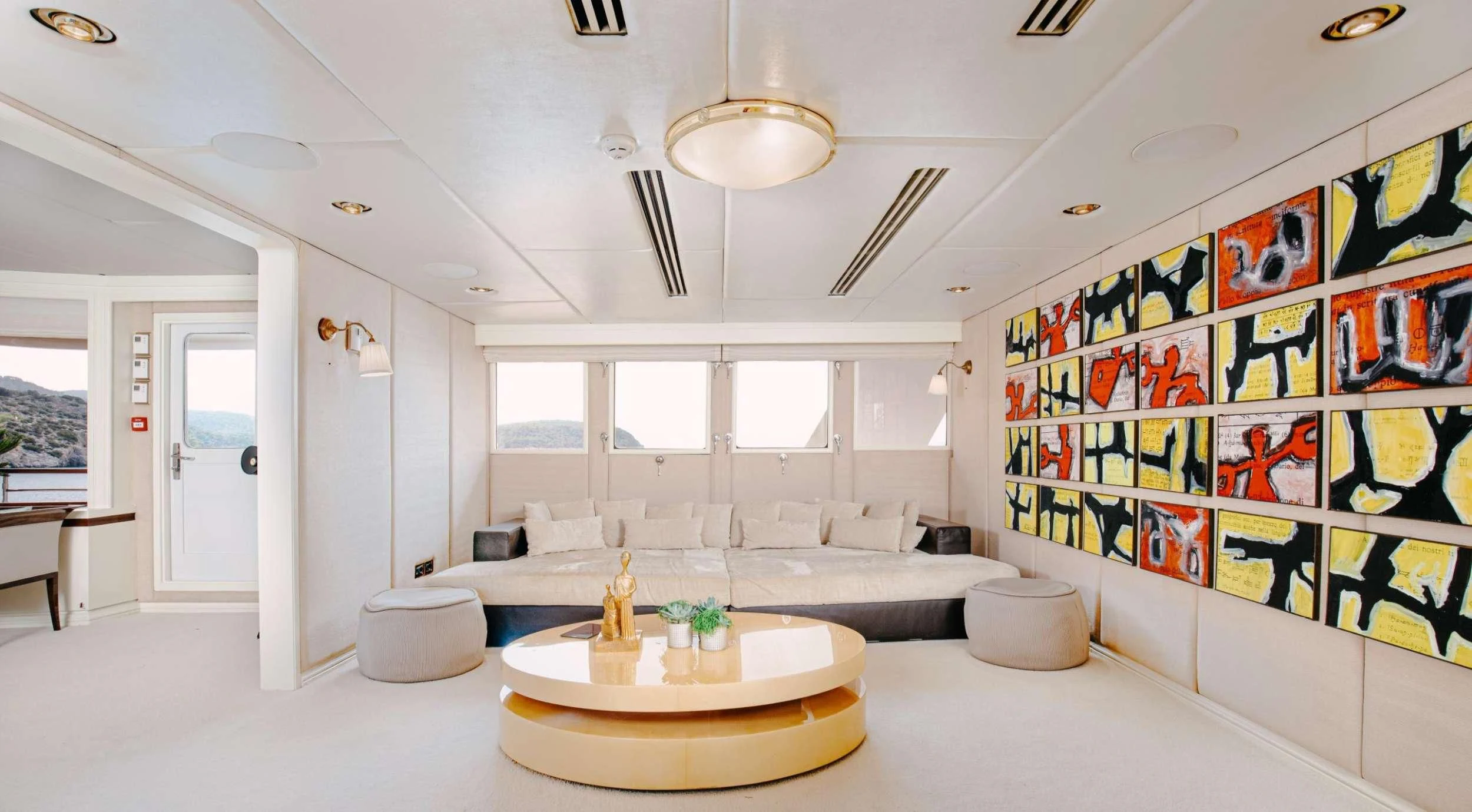 a large living room with a large chandelier aboard ITOTO Yacht for Charter