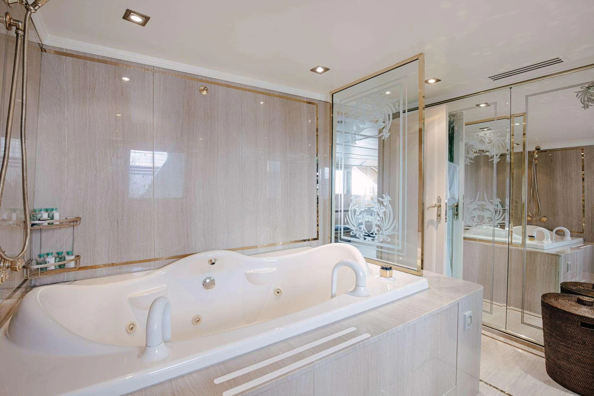 a bathroom with a bathtub and shower aboard ITOTO Yacht for Charter