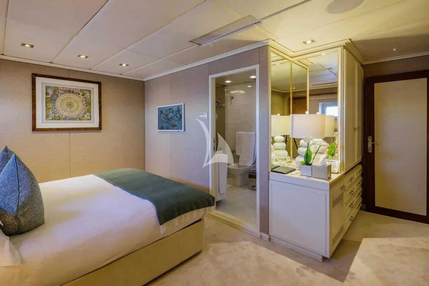 a bedroom with a bed and a mirror aboard ITOTO Yacht for Charter