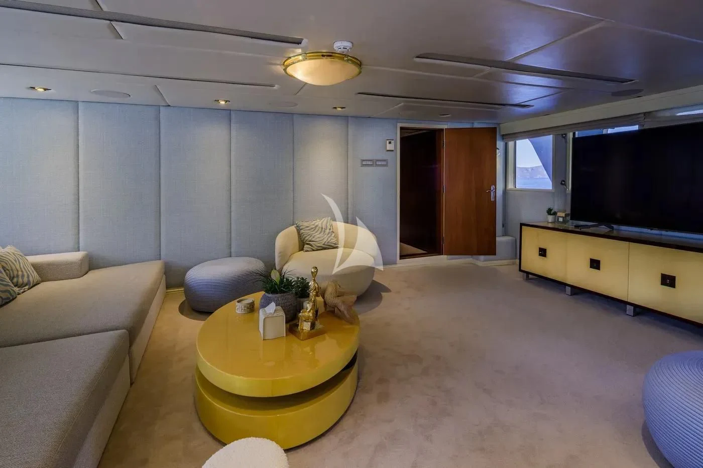 a living room with a tv and furniture aboard ITOTO Yacht for Charter