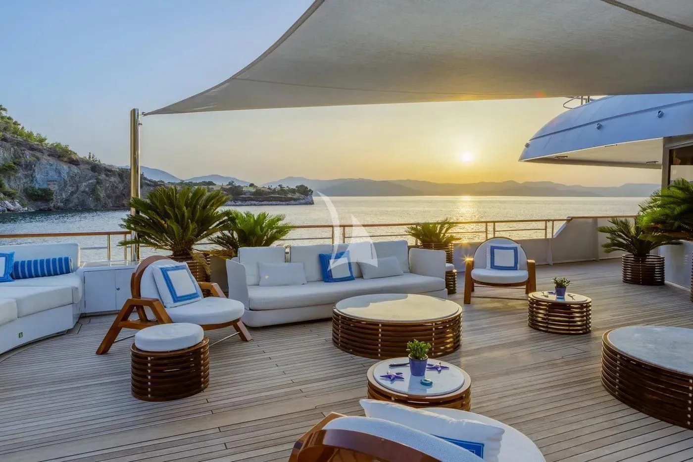 a large living room with a large patio and a large body of water aboard ITOTO Yacht for Charter