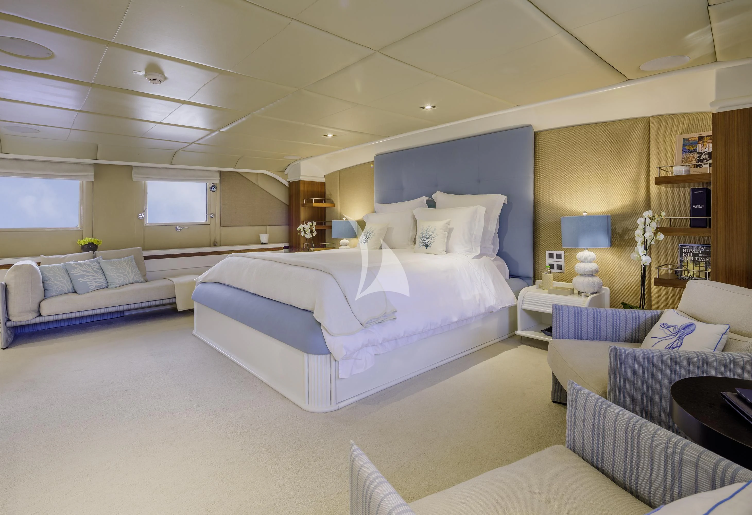 a room with a bed and a couch aboard ITOTO Yacht for Charter