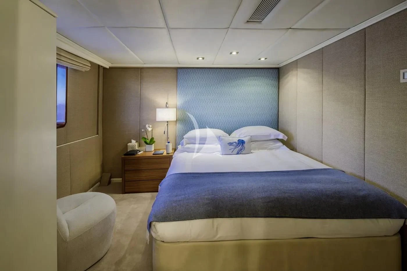 a bedroom with a bed and a chair aboard ITOTO Yacht for Charter