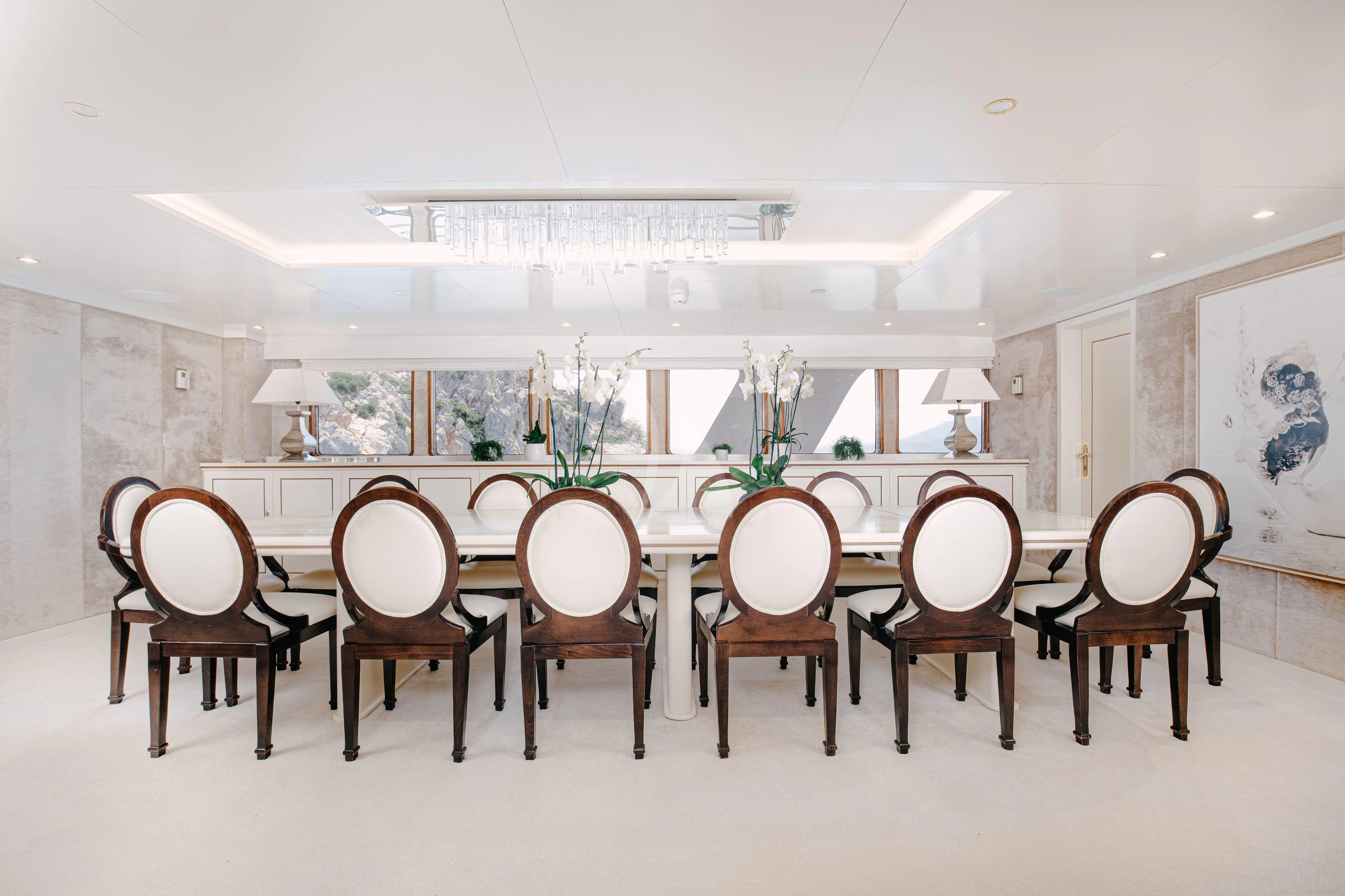 a large room with chairs and a table aboard ITOTO Yacht for Charter