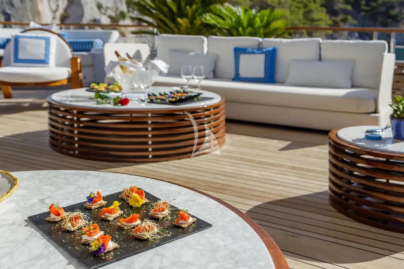 a table with plates and bowls of food on it aboard ITOTO Yacht for Charter