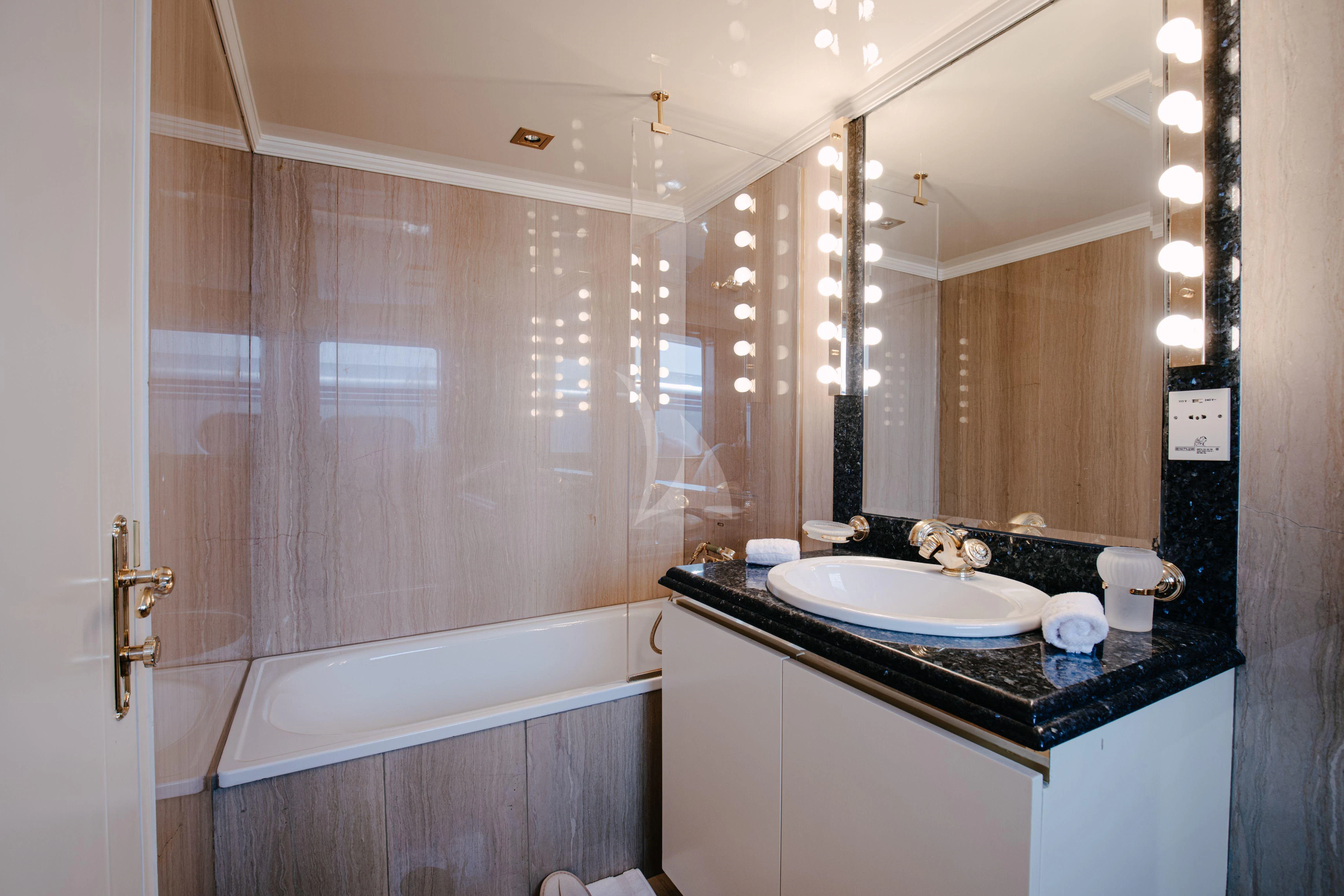 a bathroom with a sink and bathtub aboard ITOTO Yacht for Charter