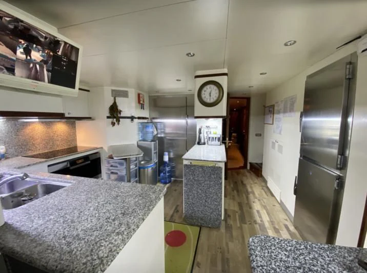 a kitchen with a large marble counter top aboard GALLUS Yacht for Sale