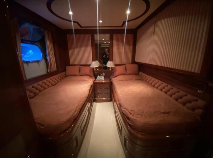 a room with a bed and a mirror aboard GALLUS Yacht for Sale