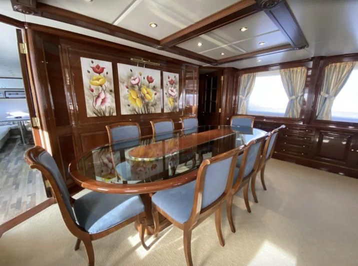 a dining room with a table aboard GALLUS Yacht for Sale