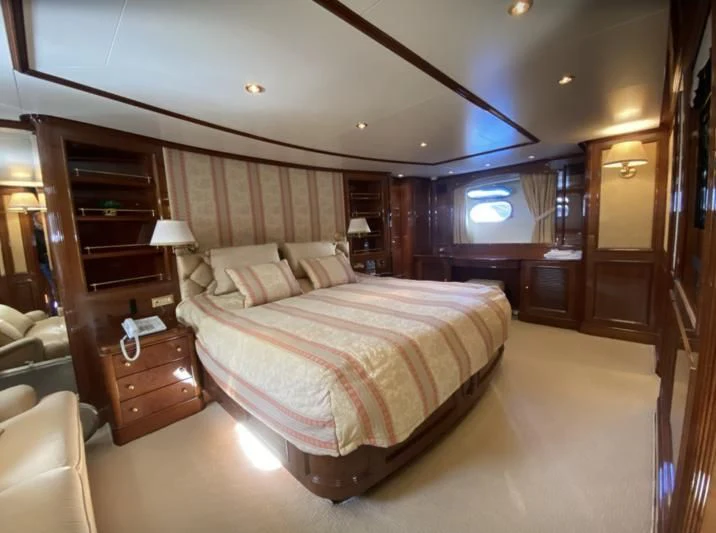 a bedroom with a bed and a desk aboard GALLUS Yacht for Sale