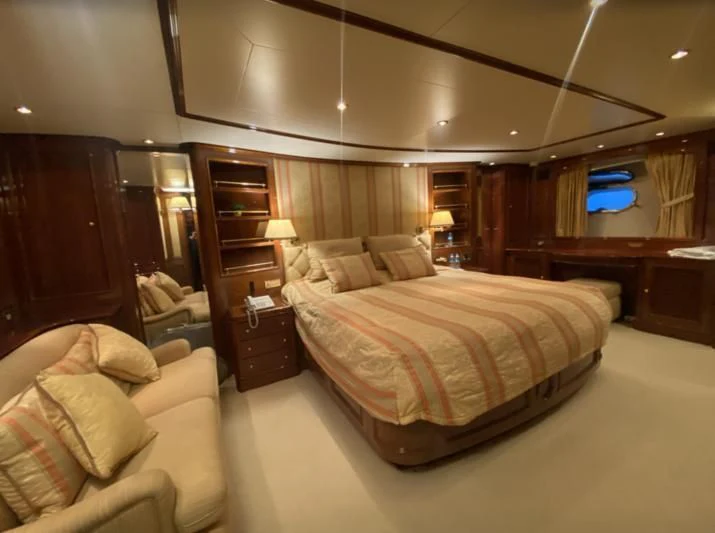 a bedroom with a bed and a desk aboard GALLUS Yacht for Sale