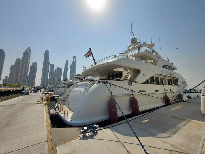 a boat parked on the side of a road with a city in the background aboard GALLUS Yacht for Sale
