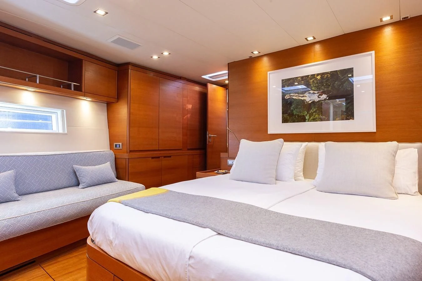 a room with a bed and a couch aboard INTO THE SUNSET Yacht for Sale