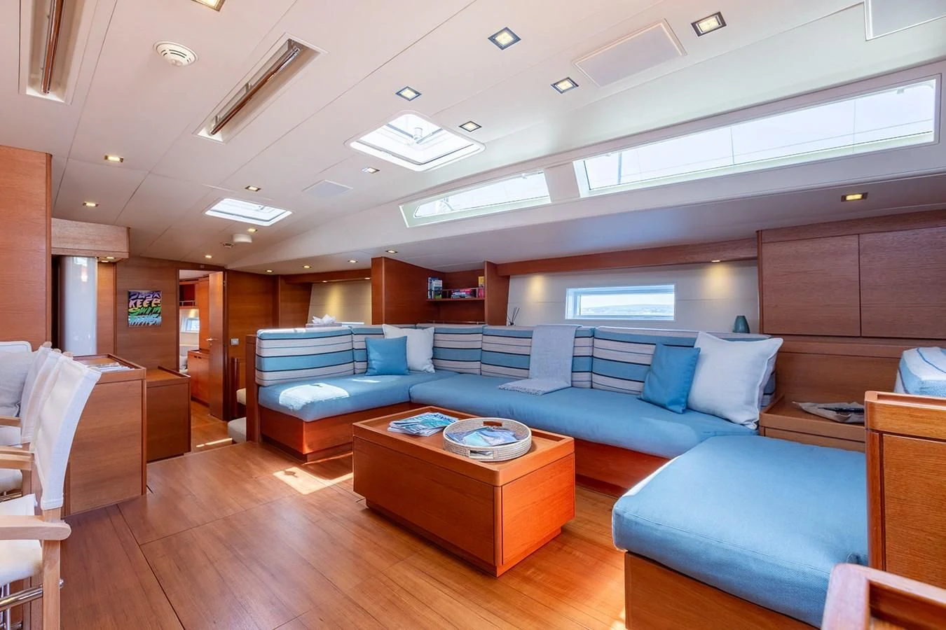 a living room with a couch and a table aboard INTO THE SUNSET Yacht for Sale