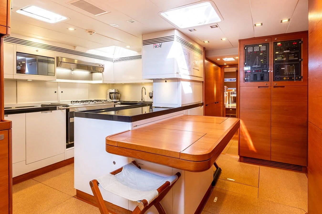 a kitchen with a counter and chairs aboard INTO THE SUNSET Yacht for Sale