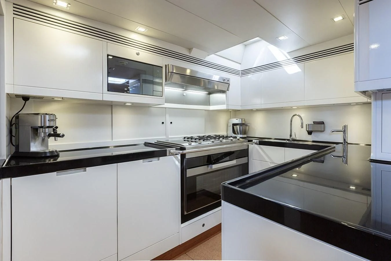 a kitchen with white cabinets aboard INTO THE SUNSET Yacht for Sale