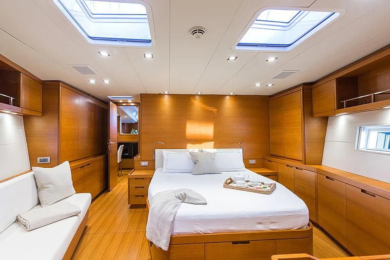 a room with a bed and a desk aboard INTO THE SUNSET Yacht for Sale