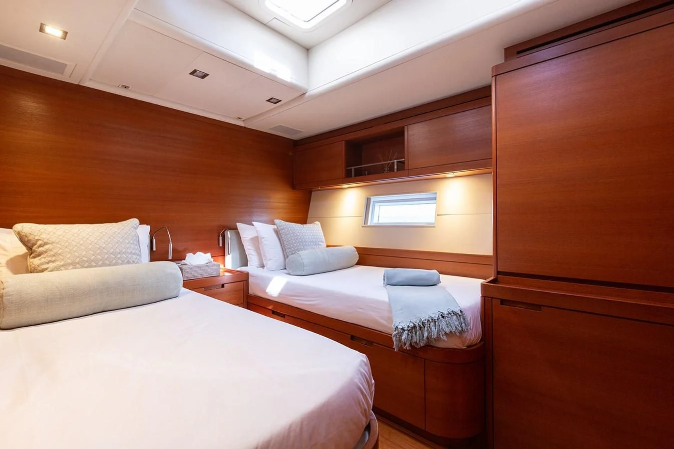 a room with a bed and a wood cabinet aboard INTO THE SUNSET Yacht for Sale