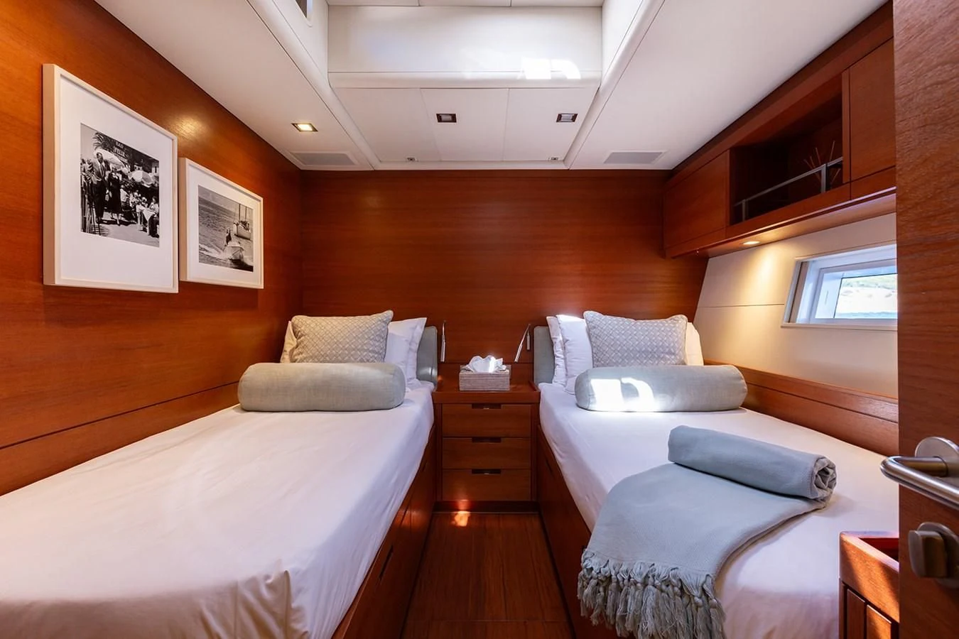 a room with a bed and a television aboard INTO THE SUNSET Yacht for Sale