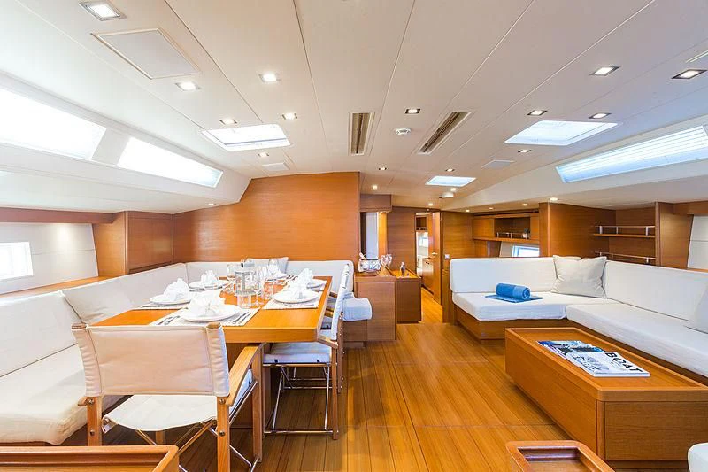 a room with a table and couch aboard INTO THE SUNSET Yacht for Sale