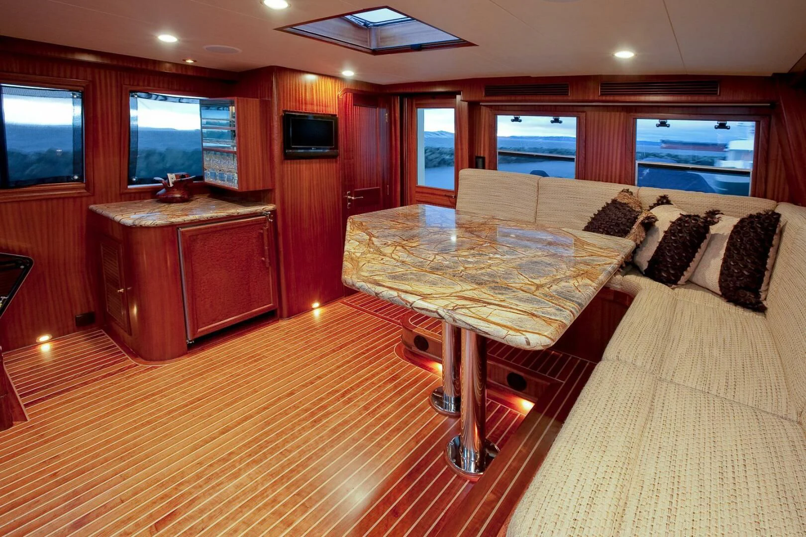 a room with a table and couch aboard AL DI LA Yacht for Sale