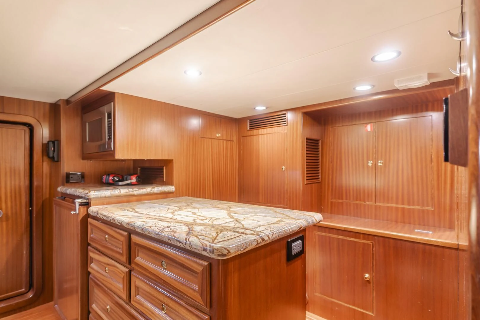 a kitchen with wooden cabinets aboard AL DI LA Yacht for Sale