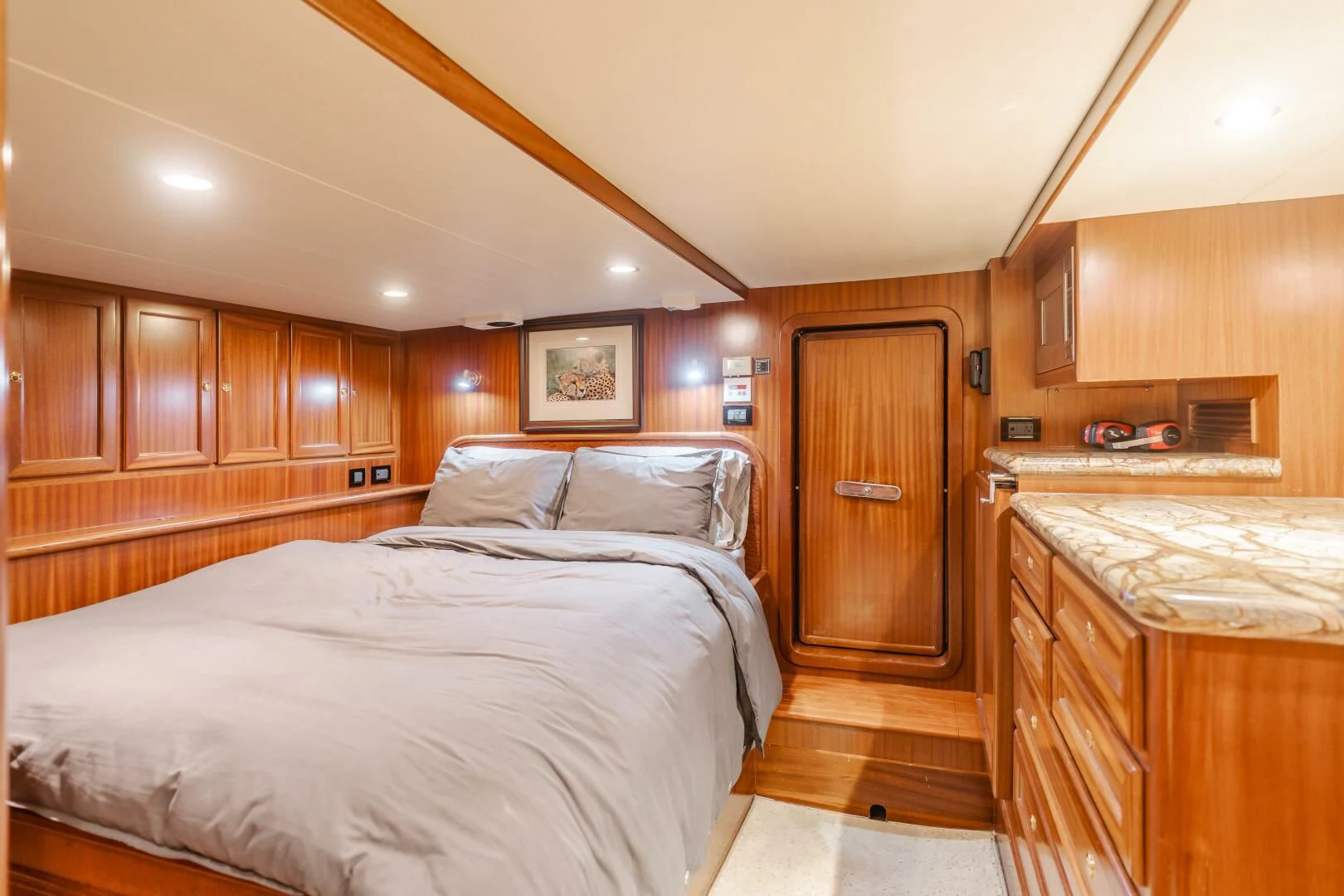 a bedroom with wooden cabinets aboard AL DI LA Yacht for Sale