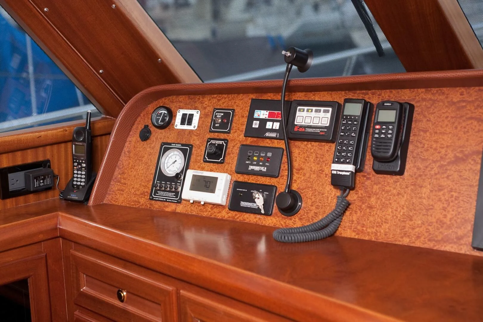 a wooden table with a group of telephones on it aboard AL DI LA Yacht for Sale