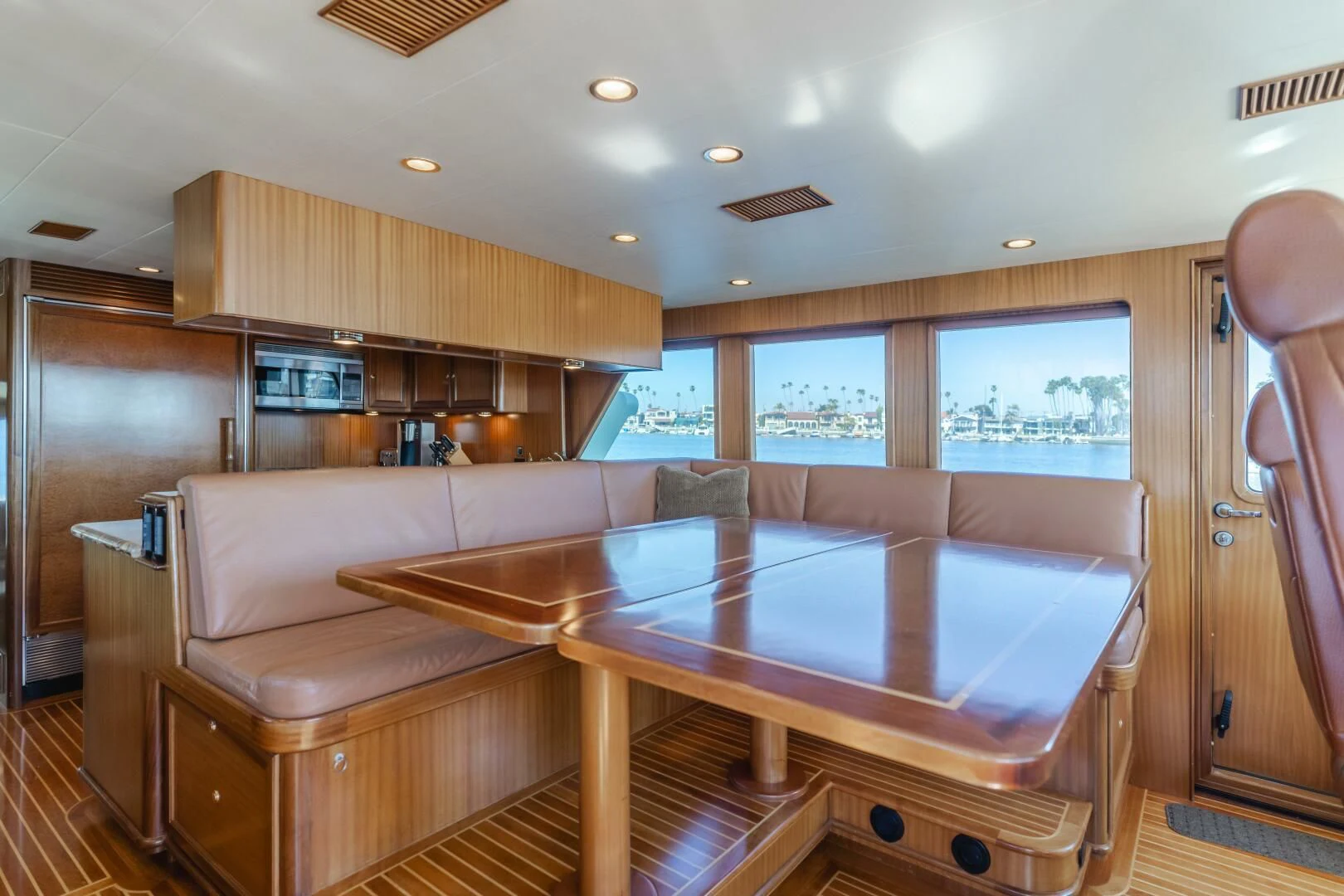 a living room with a table and couch aboard AL DI LA Yacht for Sale