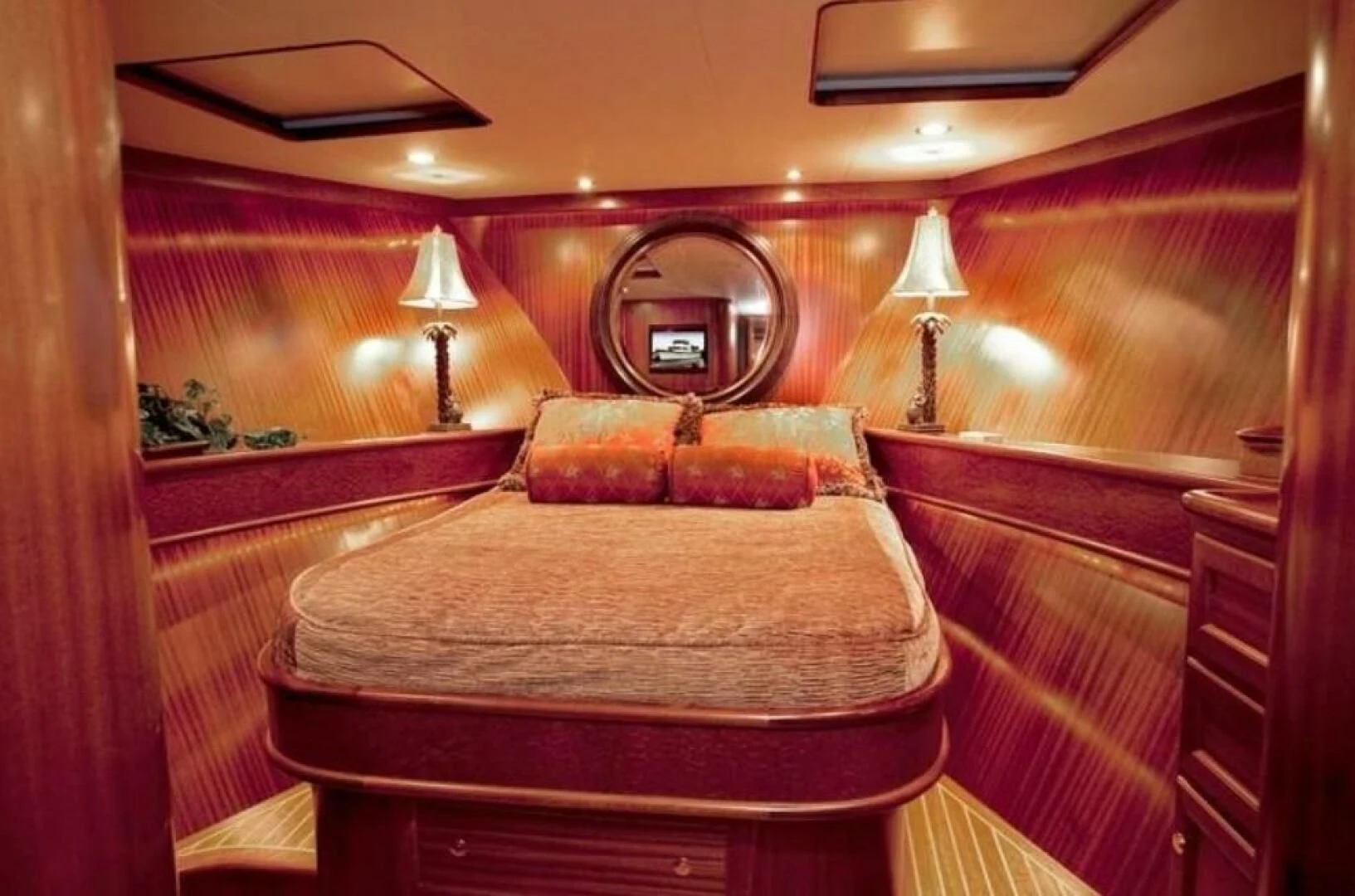 a bed with a round mirror aboard AL DI LA Yacht for Sale