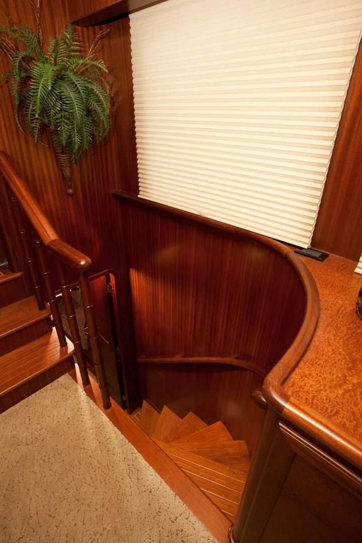 a wooden bench next to a window aboard AL DI LA Yacht for Sale