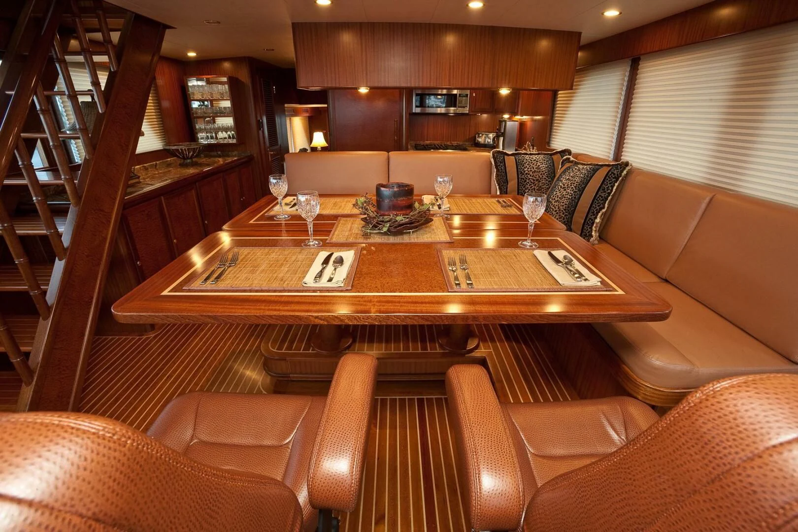 a large living room with a wood table and chairs aboard AL DI LA Yacht for Sale