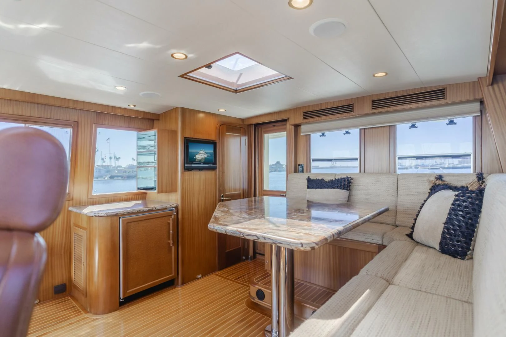 a living room with a table and couches aboard AL DI LA Yacht for Sale