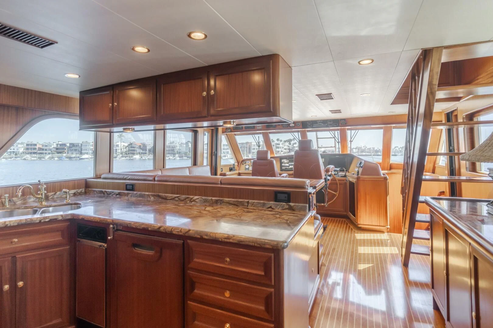 a large kitchen with wooden cabinets aboard AL DI LA Yacht for Sale