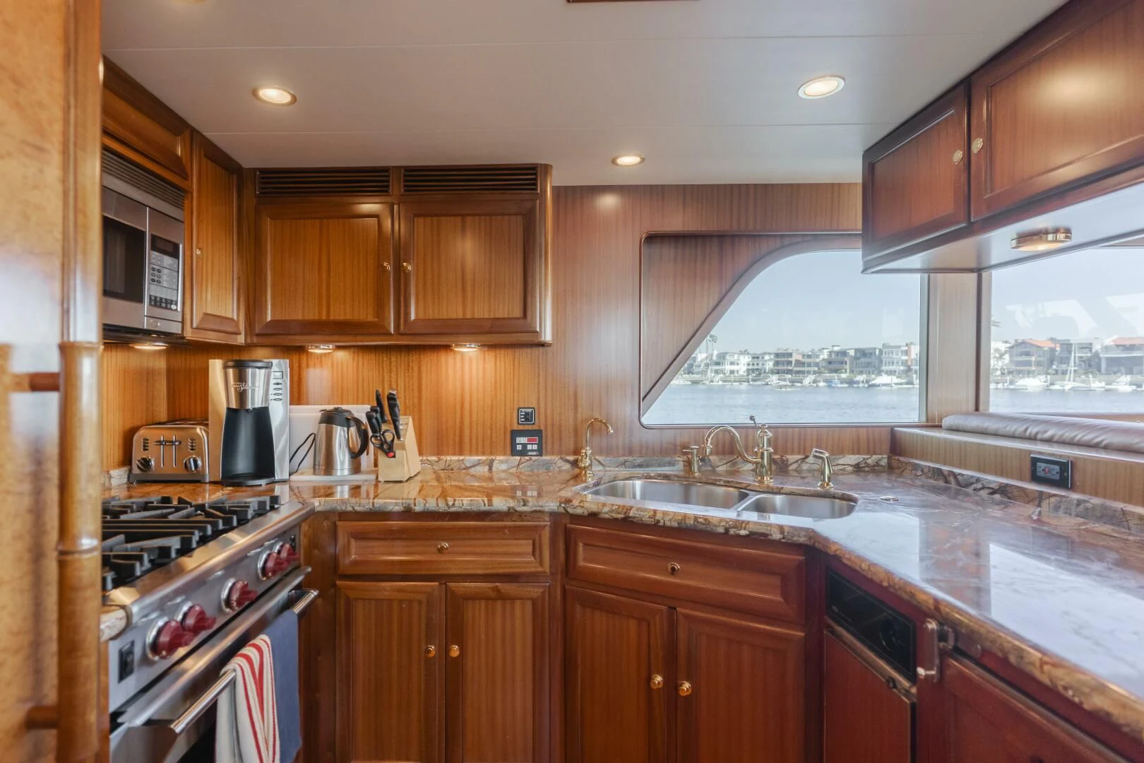 a kitchen with wooden cabinets aboard AL DI LA Yacht for Sale