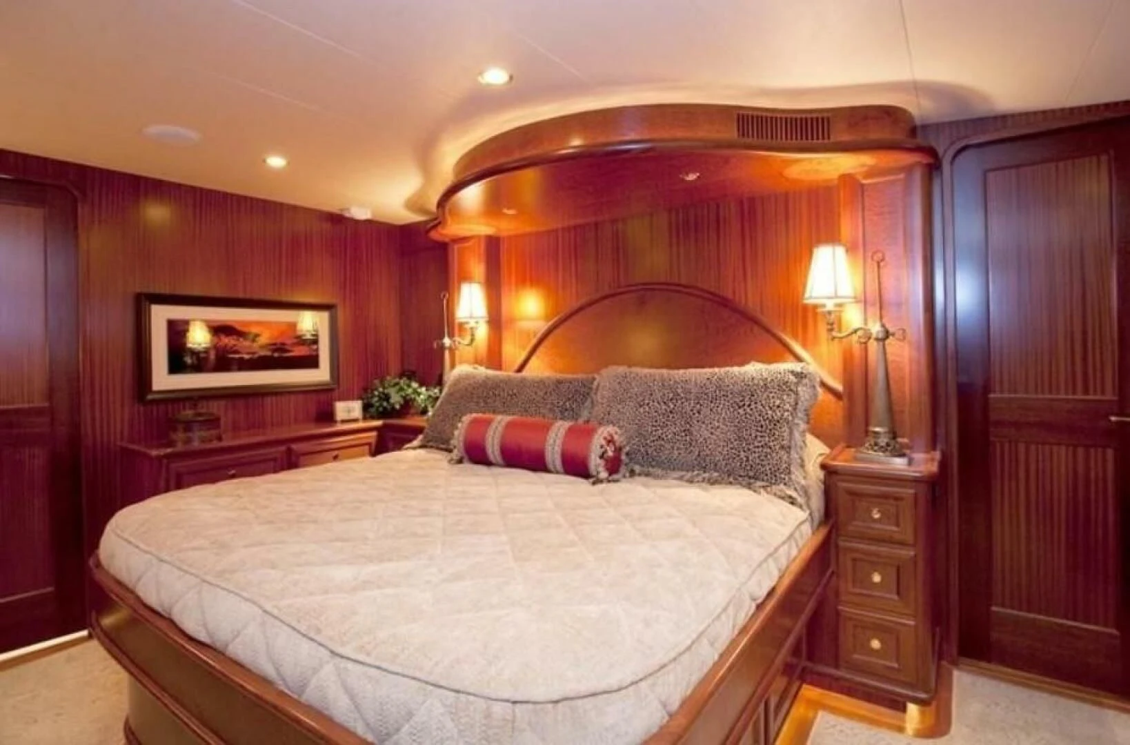 a bed with a white comforter aboard AL DI LA Yacht for Sale