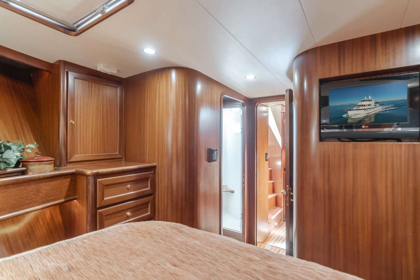 a bedroom with a bed and a television aboard AL DI LA Yacht for Sale