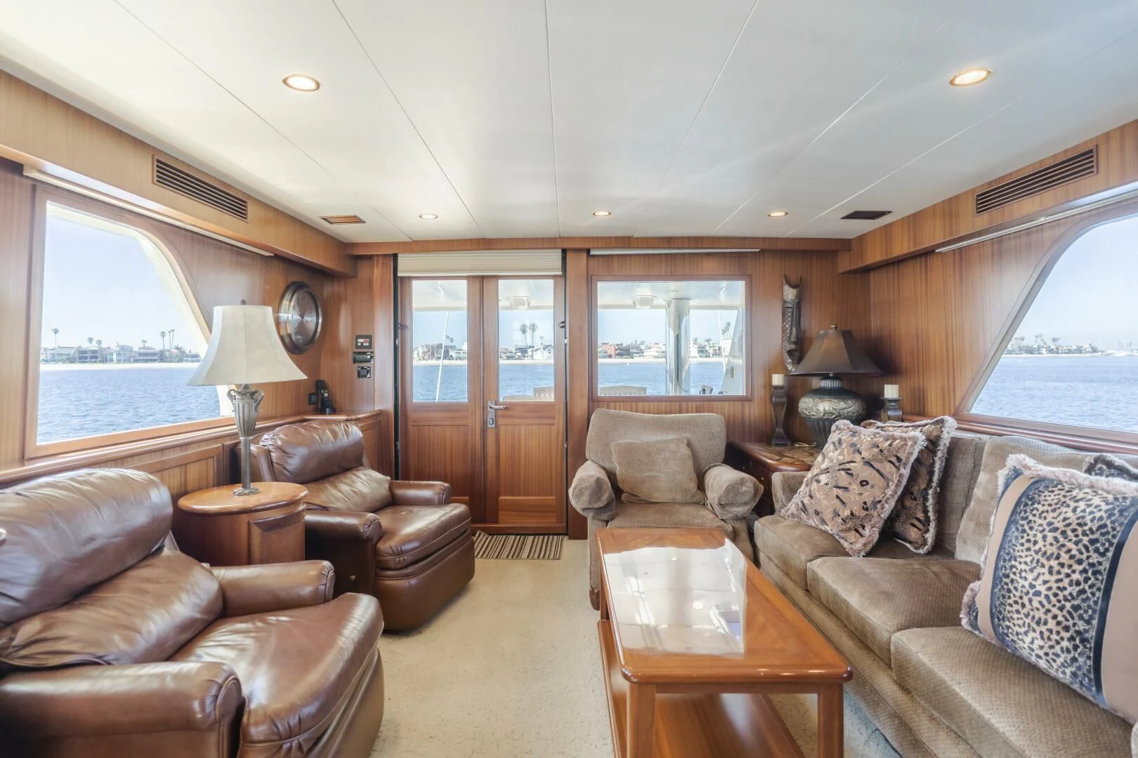 a living room with leather couches and a wood table aboard AL DI LA Yacht for Sale