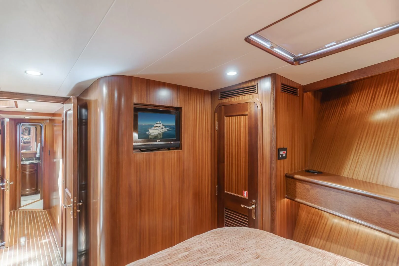 a bedroom with a tv on the wall aboard AL DI LA Yacht for Sale