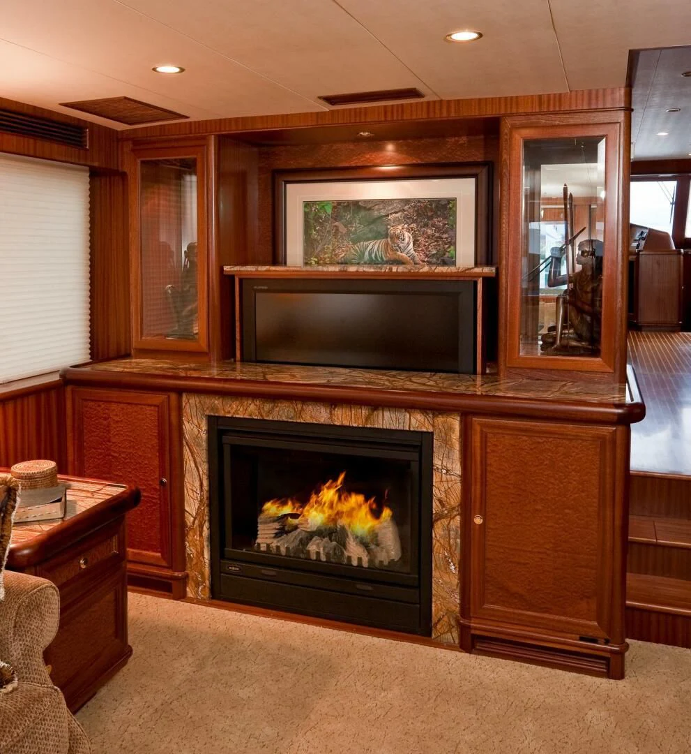 a fireplace in a living room aboard AL DI LA Yacht for Sale