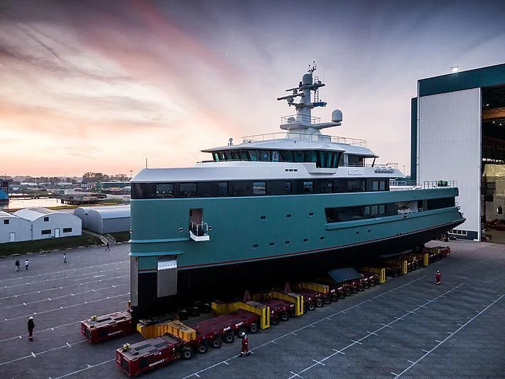 a large blue ship docked at a port aboard ANAWA Yacht for Sale