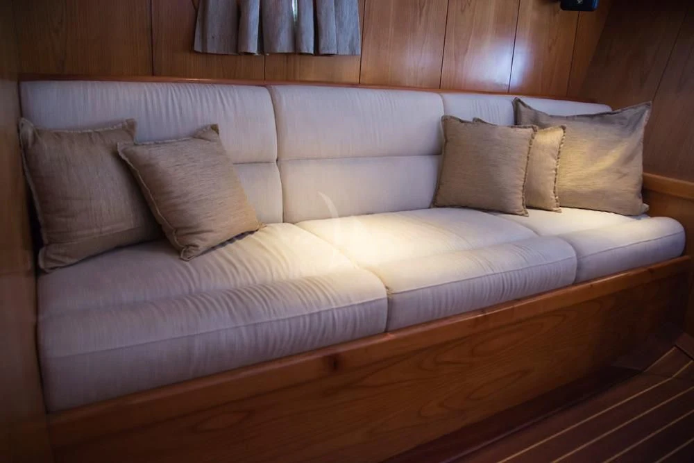 a couch with pillows aboard SCHATZ Yacht for Sale