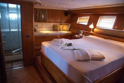 a room with a bed and a window aboard SCHATZ Yacht for Sale