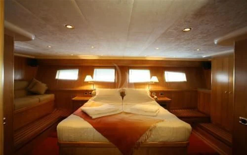 a room with a bed and a couch aboard SCHATZ Yacht for Sale