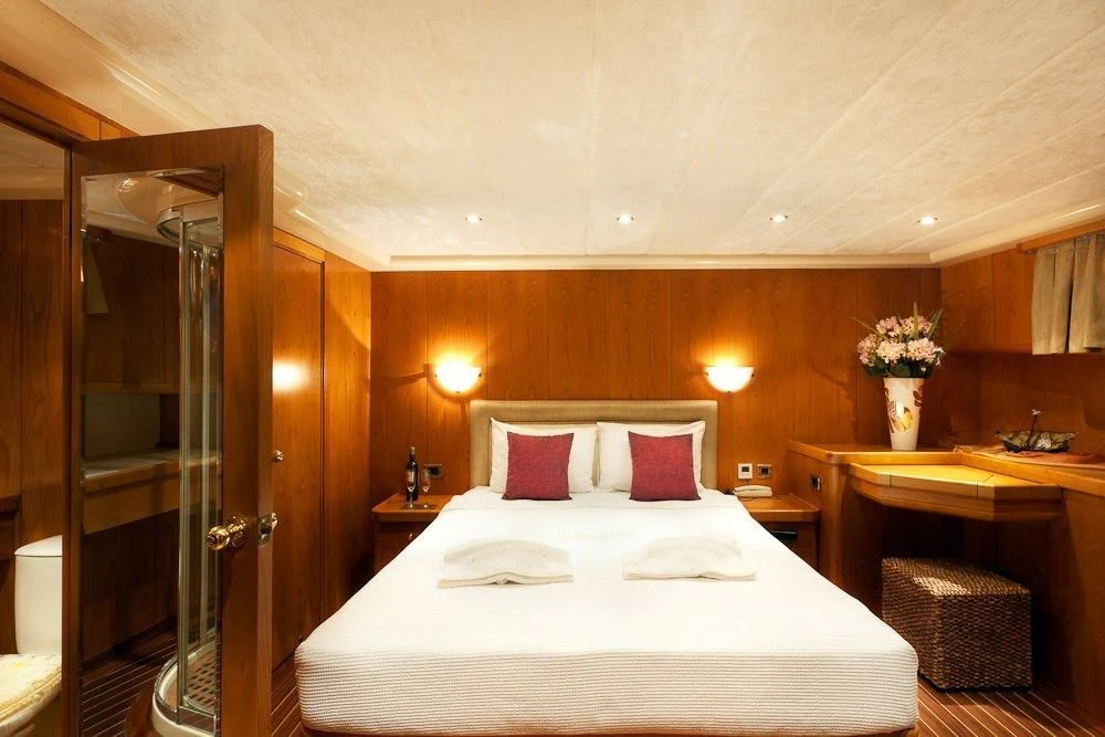 a bed with pink pillows aboard SCHATZ Yacht for Sale