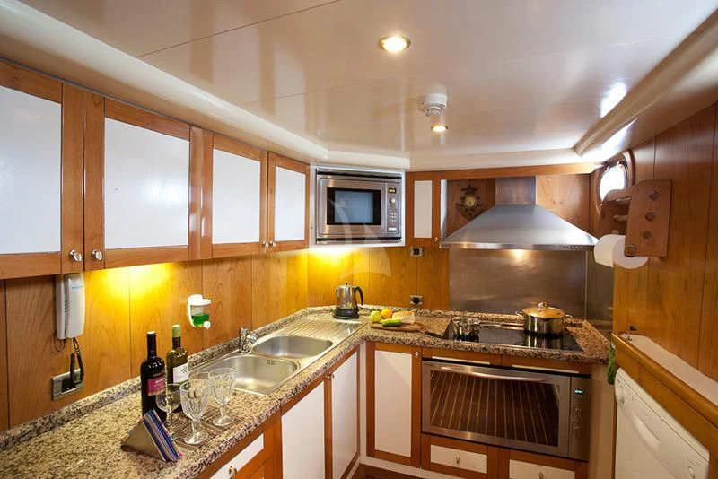 a kitchen with wooden cabinets aboard SCHATZ Yacht for Sale