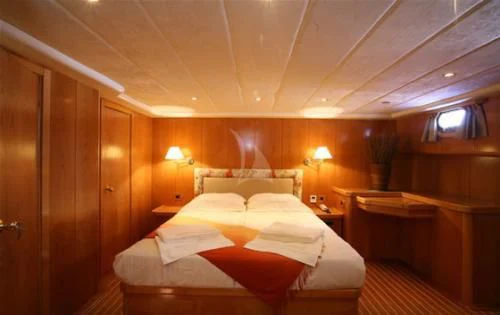 a room with a bed and a desk aboard SCHATZ Yacht for Sale