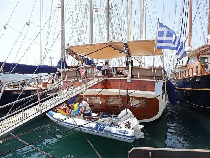 a boat with a flag on it aboard SCHATZ Yacht for Sale